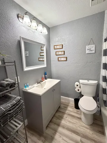 a bathroom with a sink toilet and mirror