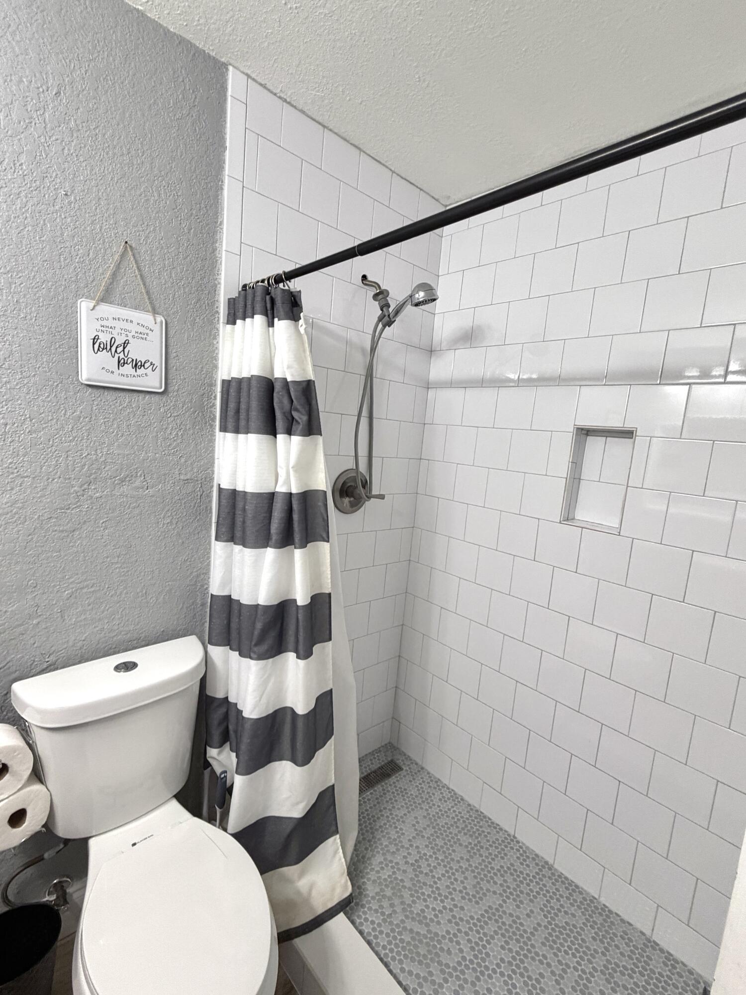 180 Southwest 21st Avenue Okeechobee, FL 34974 - Photo 16 of 21 a white toilet sitting next to a shower curtain