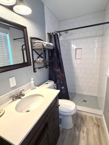 a bathroom with a sink toilet and shower