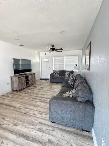 a large room with furniture and flat screen tv