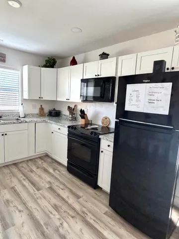 a kitchen with stainless steel appliances granite countertop a sink and cabinets