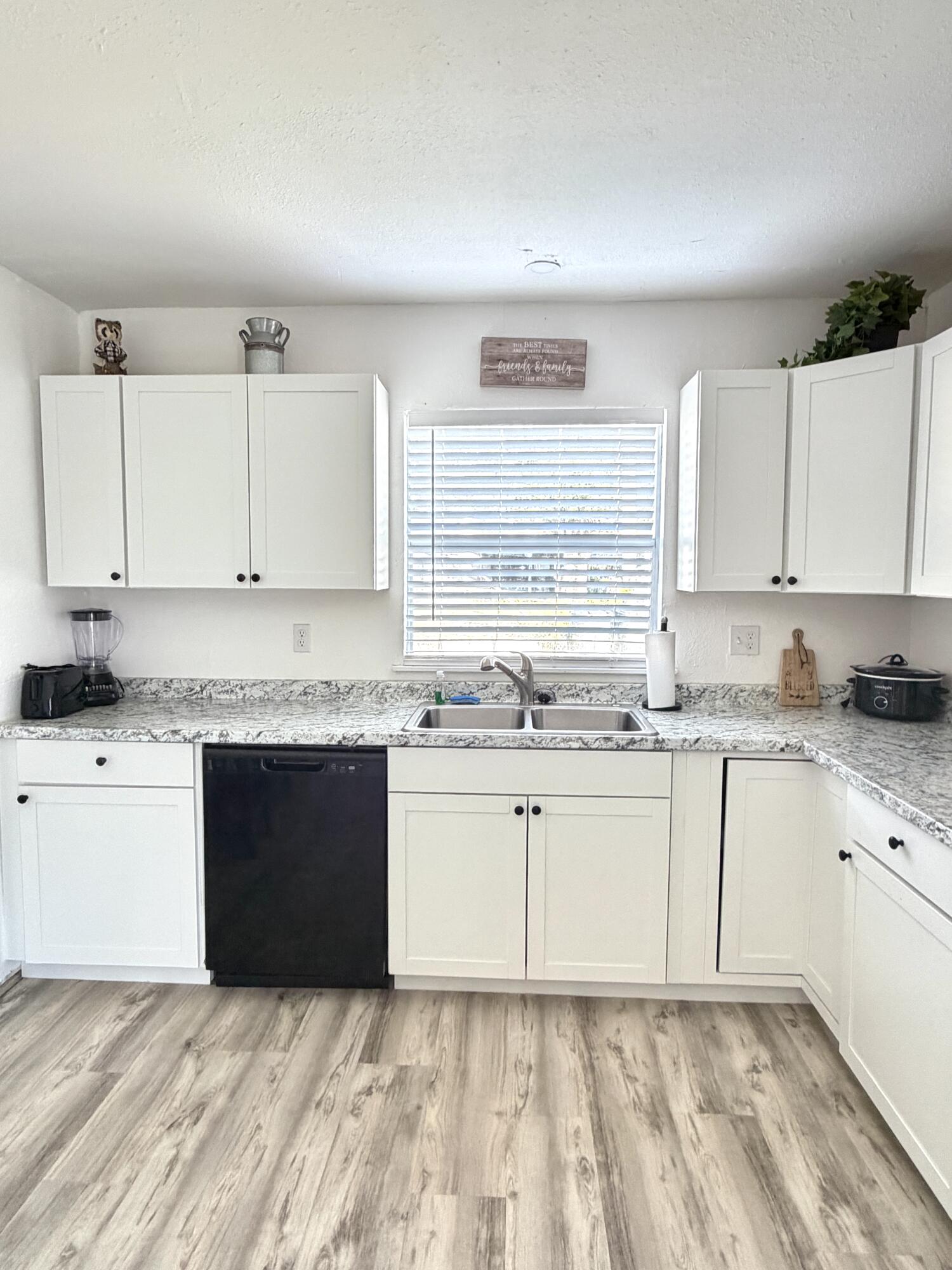 180 Southwest 21st Avenue Okeechobee, FL 34974 - Photo 10 of 21 a white kitchen with granite countertop white cabinets and white appliances