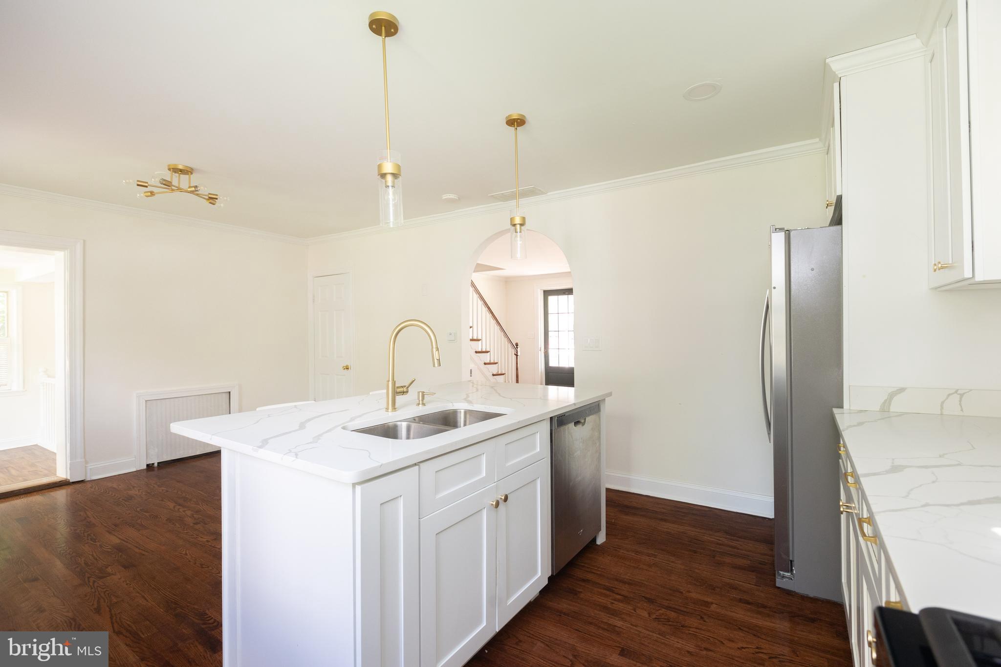 710 Regester Avenue Baltimore, MD 21212 - Photo 16 of 48 a kitchen that has a sink a refrigerator and wooden floor