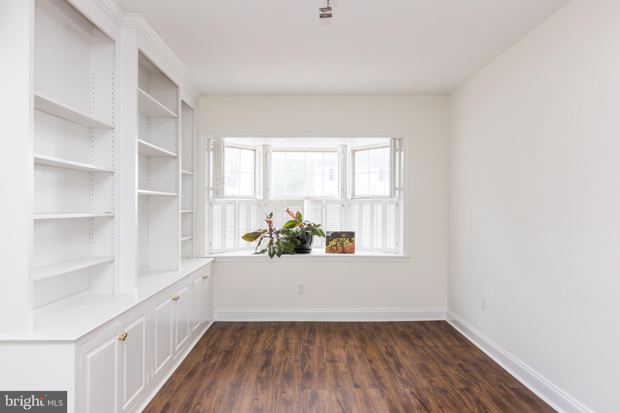710 Regester Avenue Baltimore, MD 21212 - Photo 20 of 48 a view of an empty room with a window and wooden floor