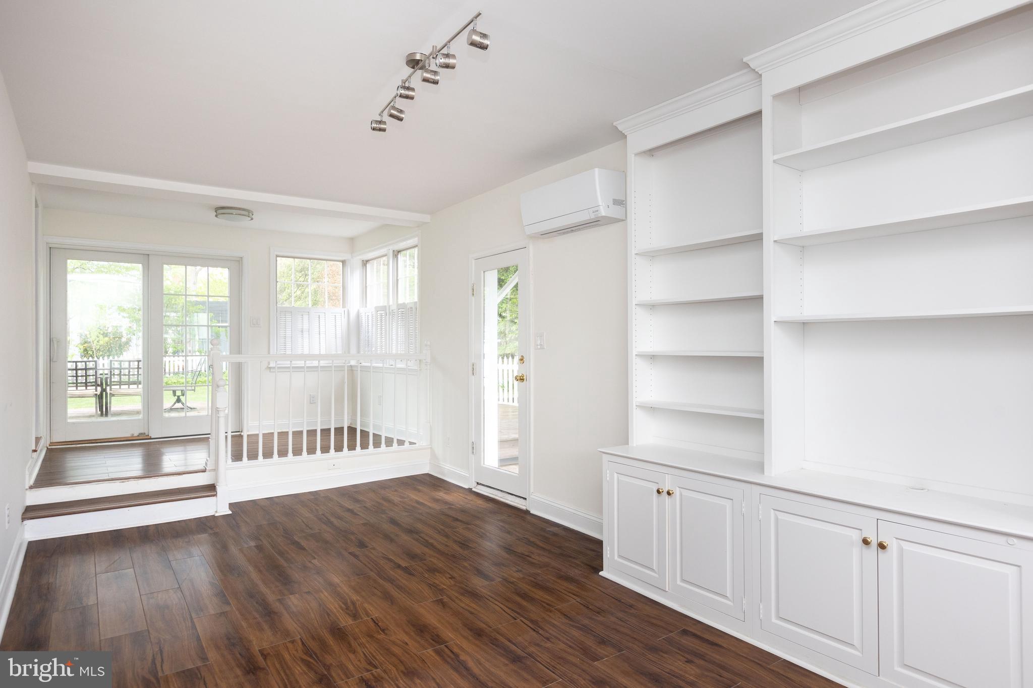 710 Regester Avenue Baltimore, MD 21212 - Photo 21 of 48 a view of an empty room with a window and wooden floor