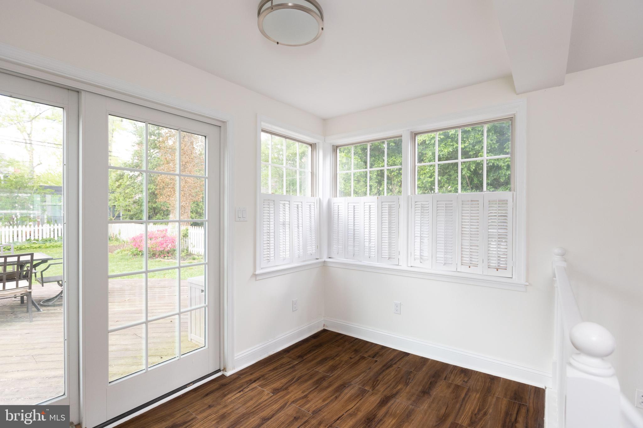 710 Regester Avenue Baltimore, MD 21212 - Photo 22 of 48 a view of an empty room with wooden floor and a window