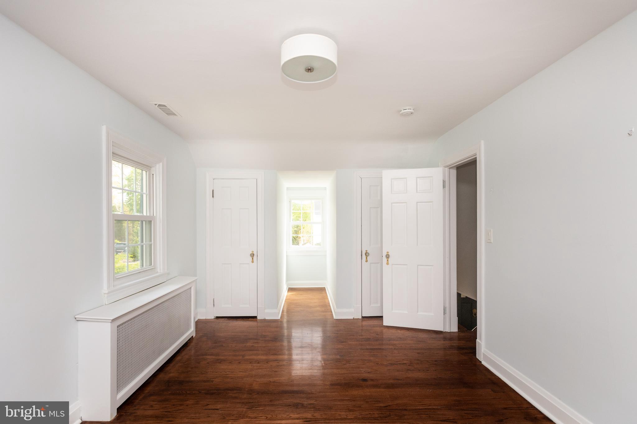 710 Regester Avenue Baltimore, MD 21212 - Photo 23 of 48 a view of an empty room with wooden floor and a window