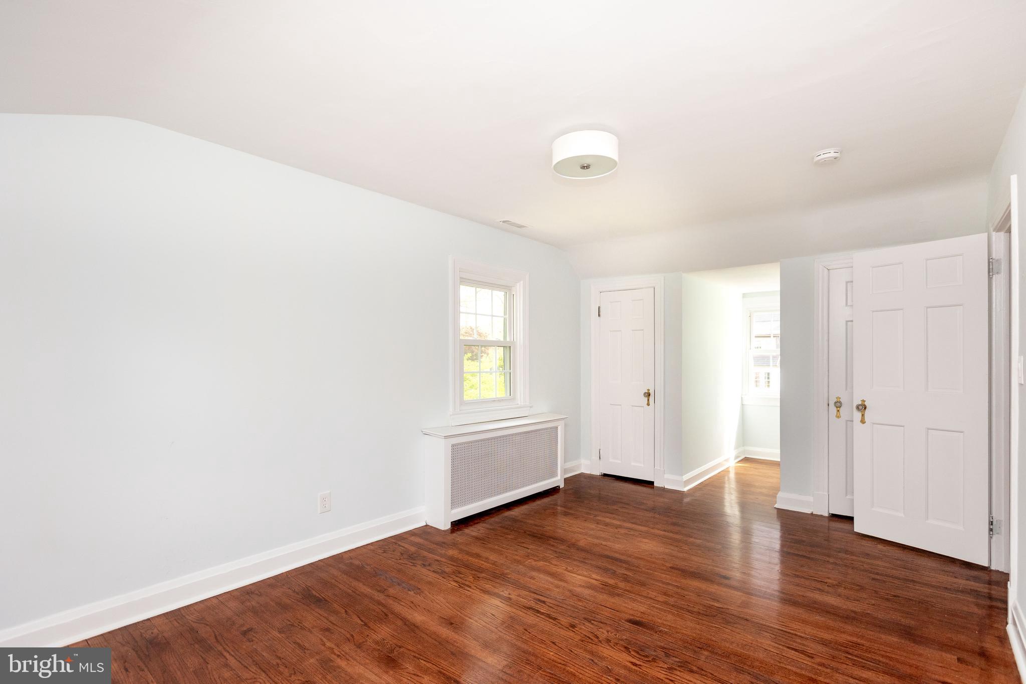 710 Regester Avenue Baltimore, MD 21212 - Photo 24 of 48 an empty room with wooden floor and windows
