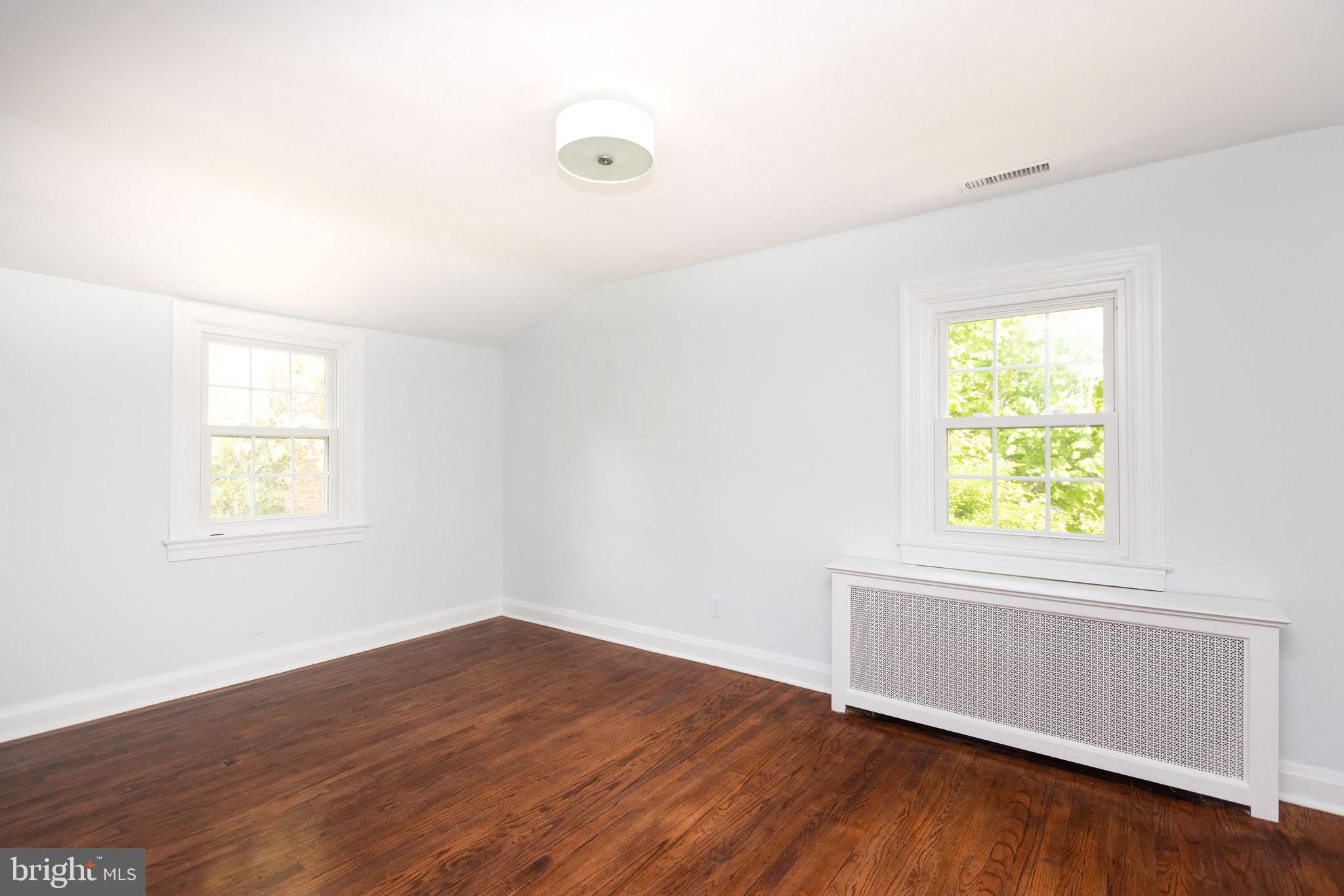 710 Regester Avenue Baltimore, MD 21212 - Photo 25 of 48 an empty room with wooden floor and windows