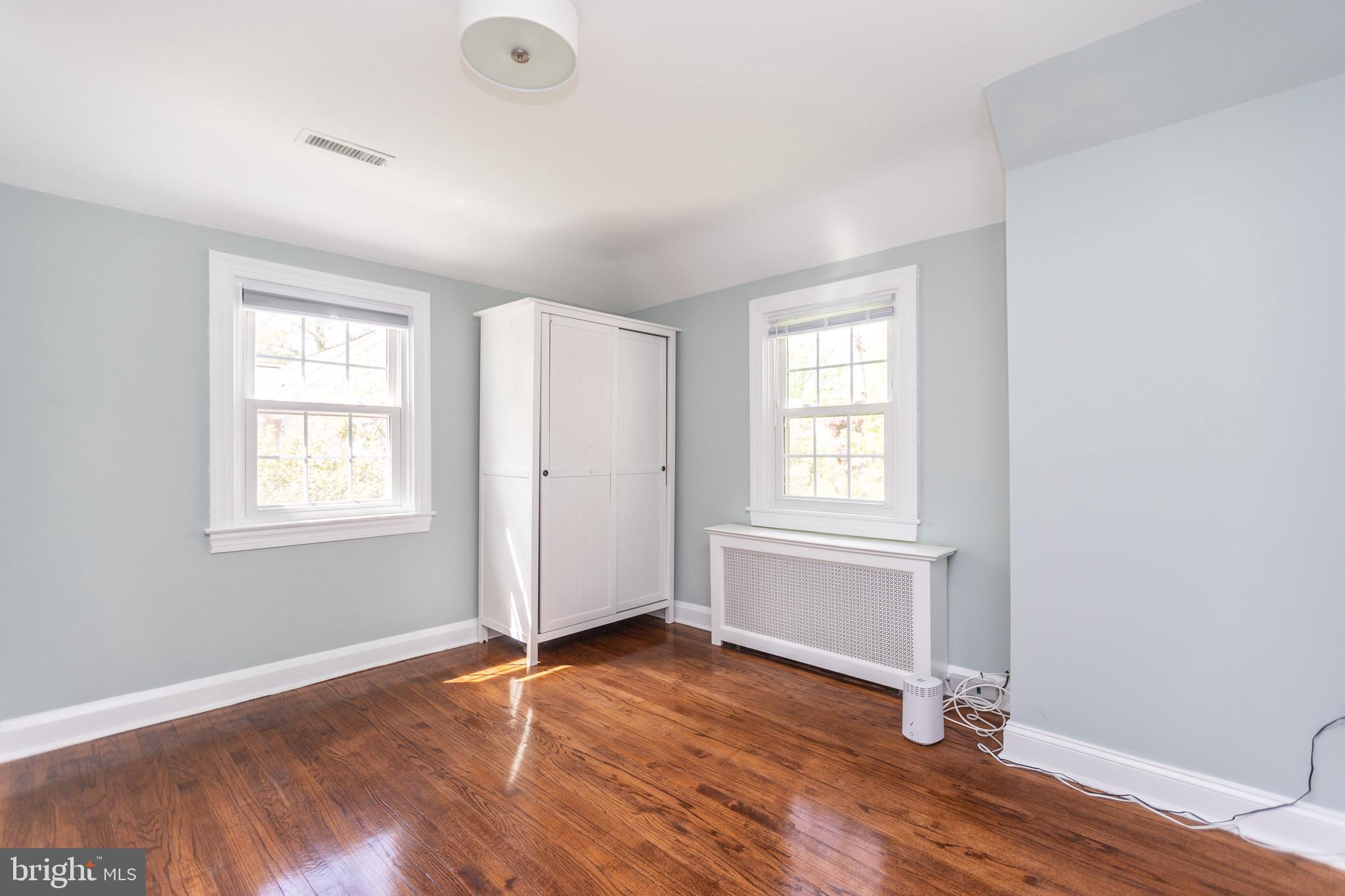 710 Regester Avenue Baltimore, MD 21212 - Photo 26 of 48 an empty room with wooden floor and windows