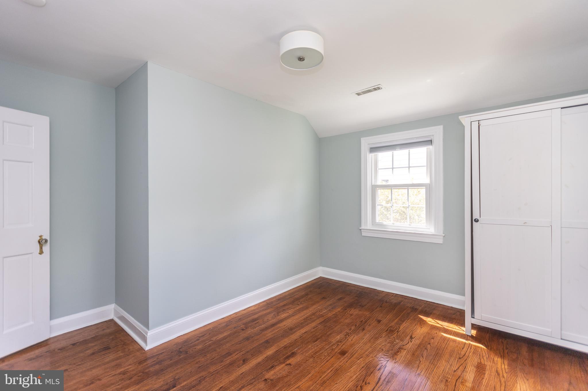 710 Regester Avenue Baltimore, MD 21212 - Photo 27 of 48 an empty room with wooden floor and windows