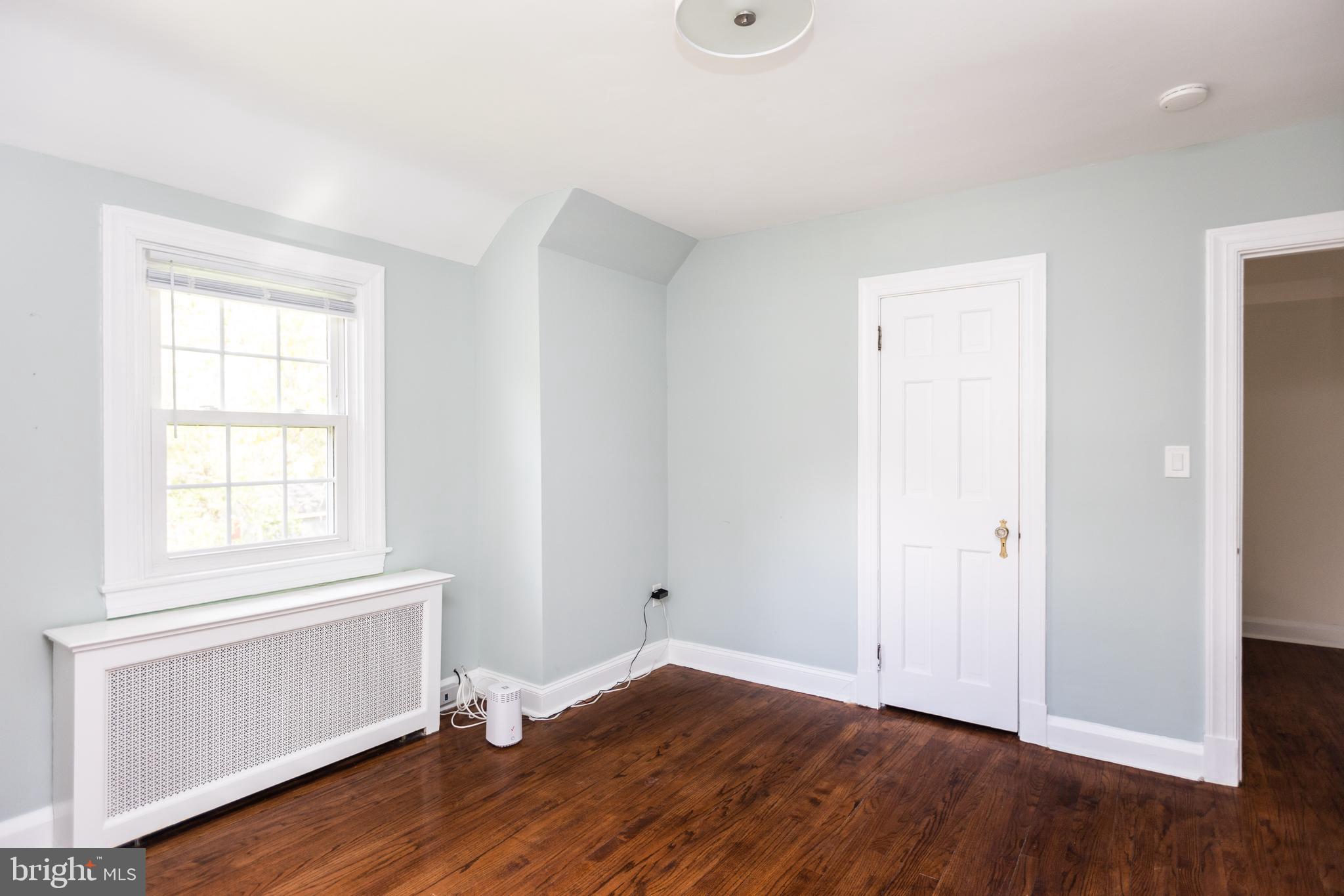 710 Regester Avenue Baltimore, MD 21212 - Photo 28 of 48 an empty room with wooden floor and window