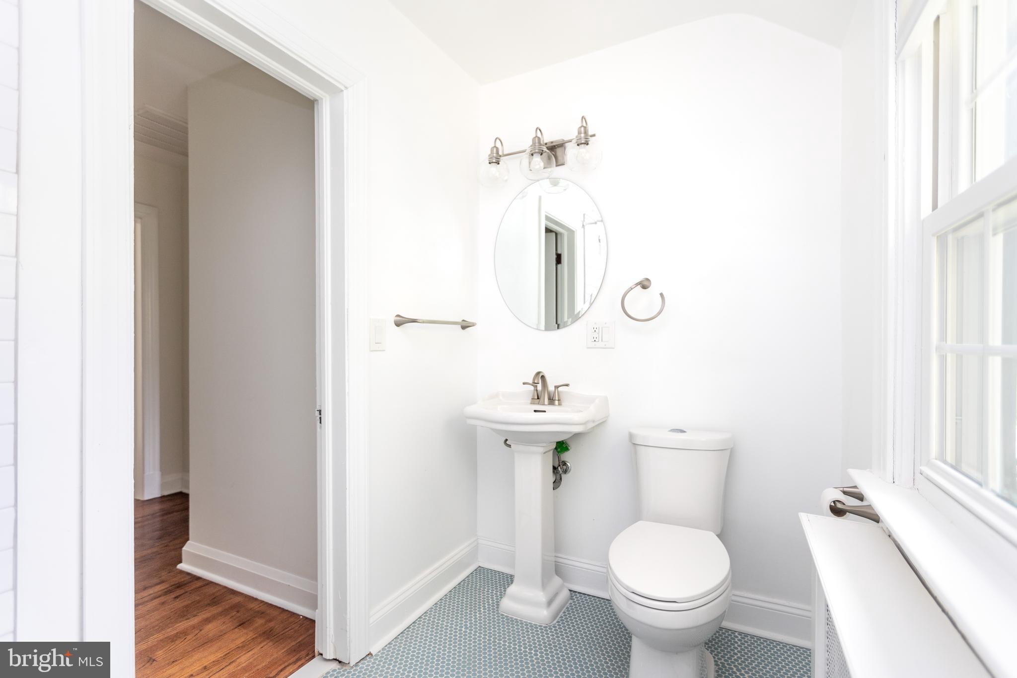 710 Regester Avenue Baltimore, MD 21212 - Photo 29 of 48 a bathroom with a toilet sink and mirror