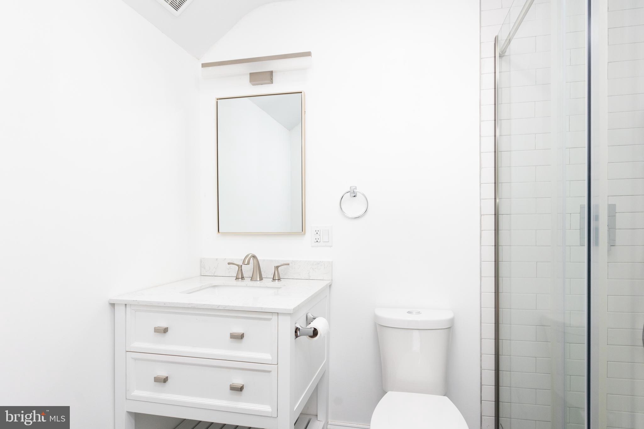 710 Regester Avenue Baltimore, MD 21212 - Photo 34 of 48 a bathroom with a toilet sink and mirror