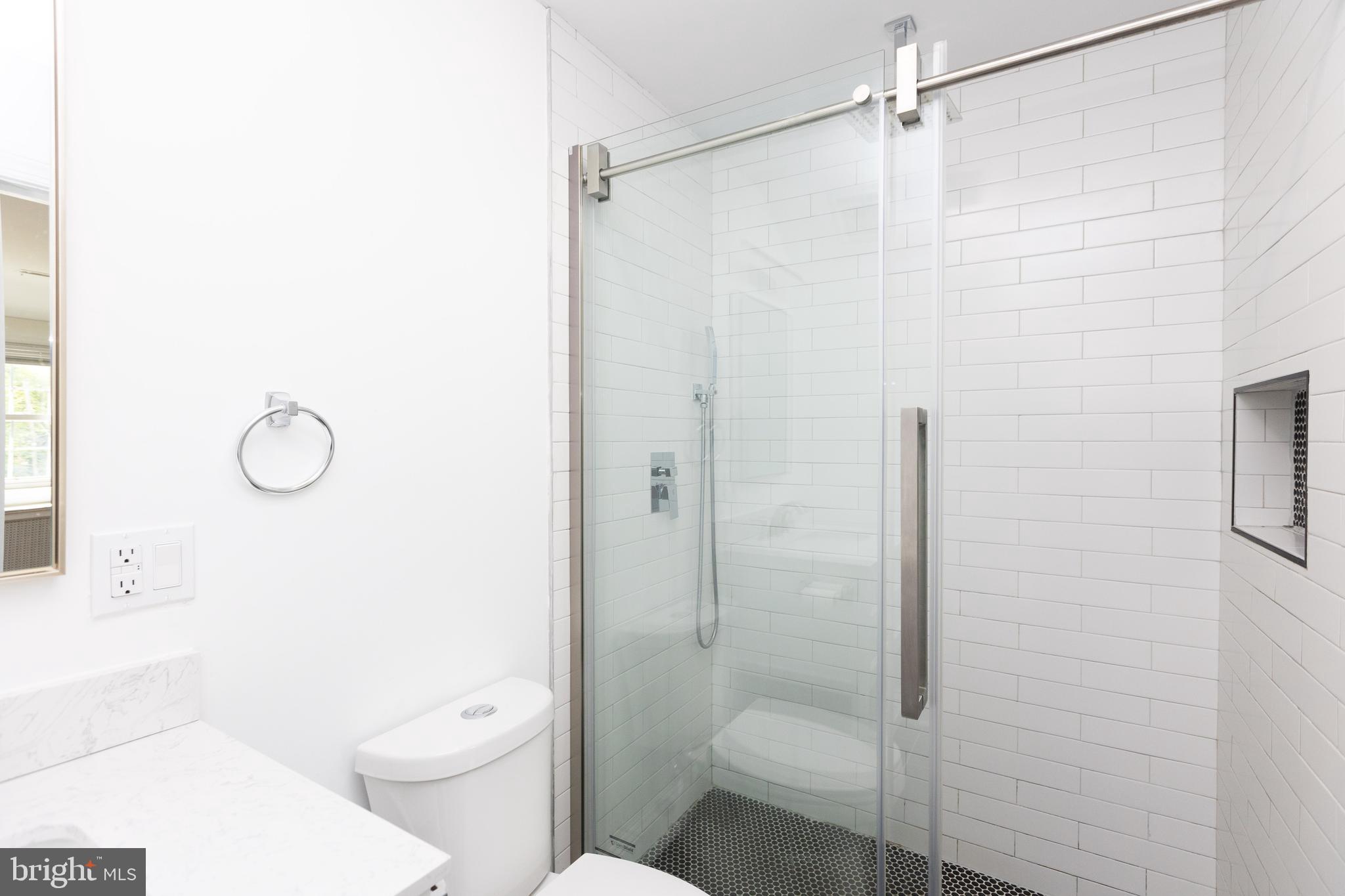 710 Regester Avenue Baltimore, MD 21212 - Photo 35 of 48 a bathroom with a shower a toilet and a sink