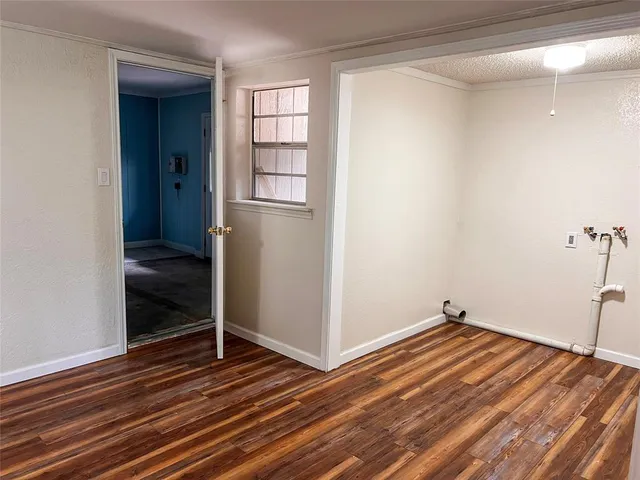 a view of a room with wooden floor