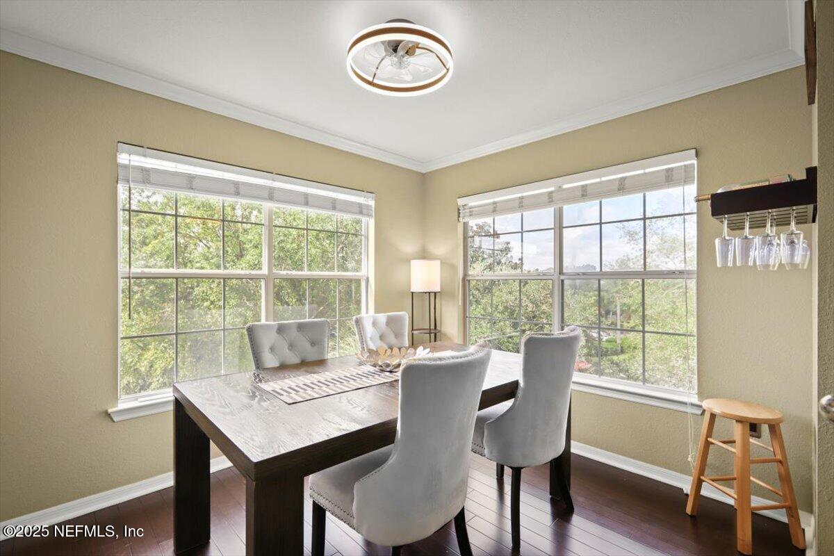10961 Burnt Mill Road, Unit 1132 Jacksonville, FL 32256 - Photo 14 of 47 a view of a dining room with furniture window and wooden floor
