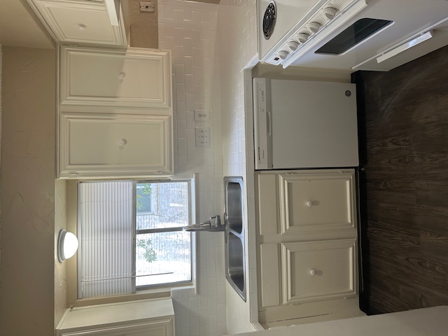 1001 Ridgeline Drive Round Rock, TX 78664 - Photo 3 of 11 a kitchen with granite countertop white cabinets and a sink