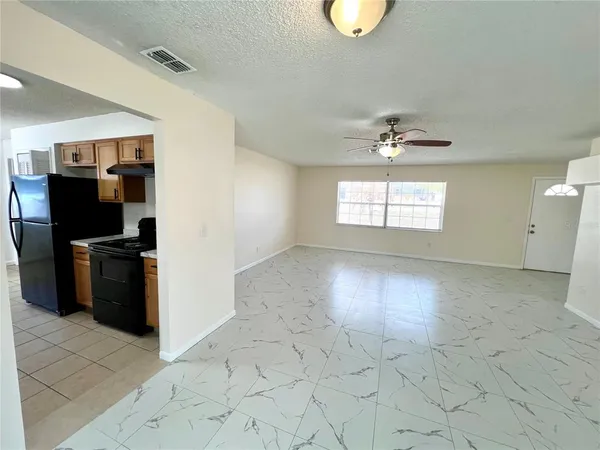 a view of a kitchen with a dishwasher cabinets and a window