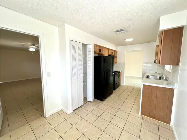 a kitchen with stainless steel appliances a refrigerator and a sink