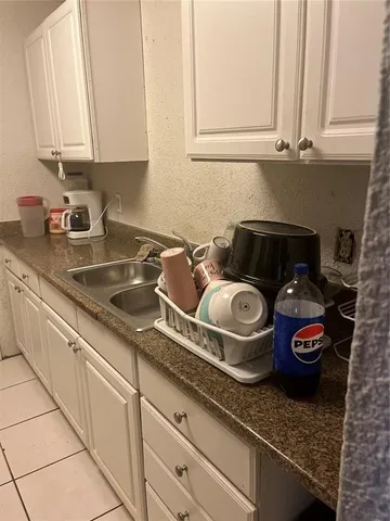 a kitchen with granite countertop cabinets and a stove