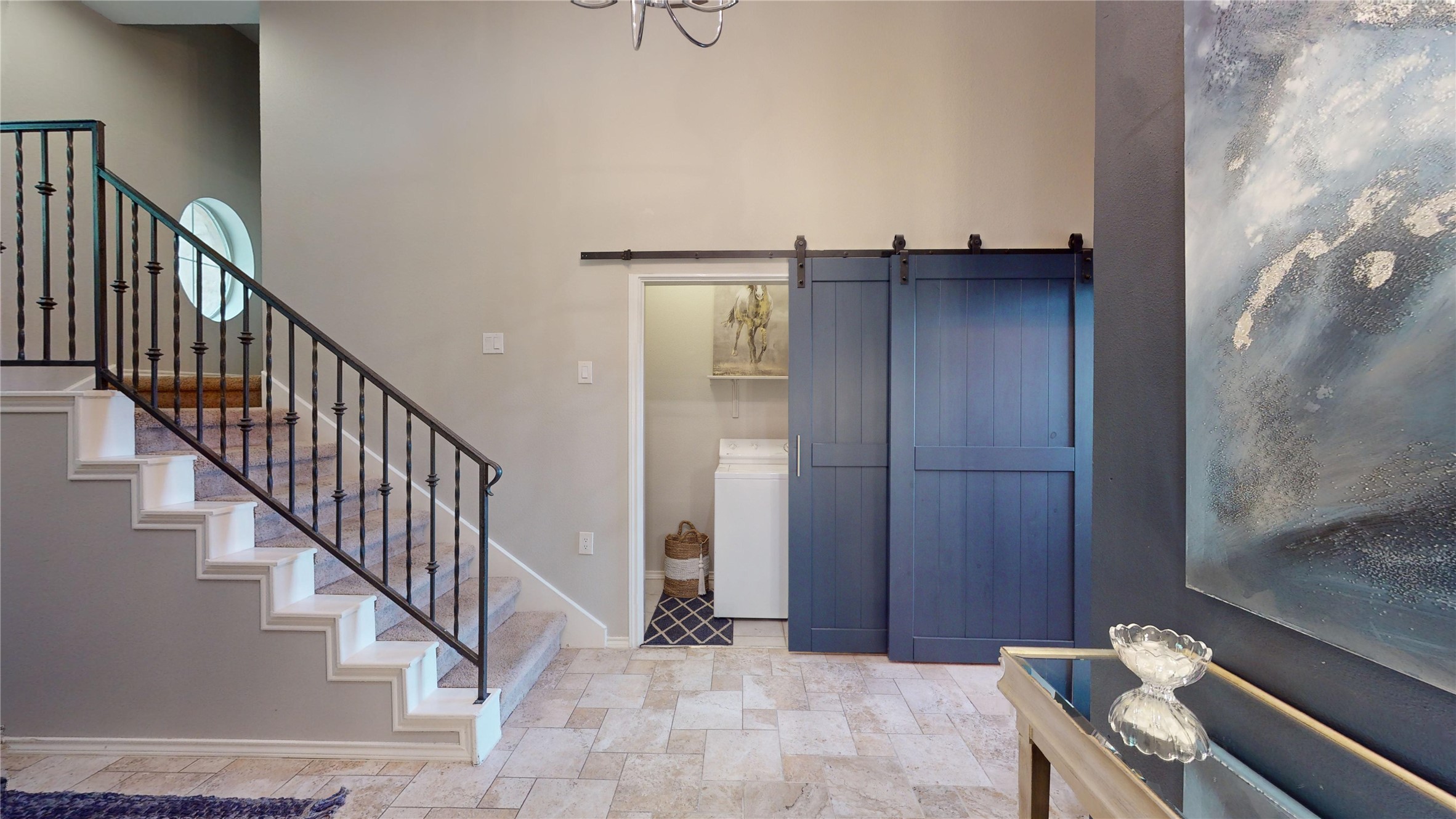2918 Ranch Road 620, Unit 297 Austin, TX 78734 - Photo 11 of 37 Foyer entrance featuring stone finish flooring, a barn door, and washer / clothes dryer