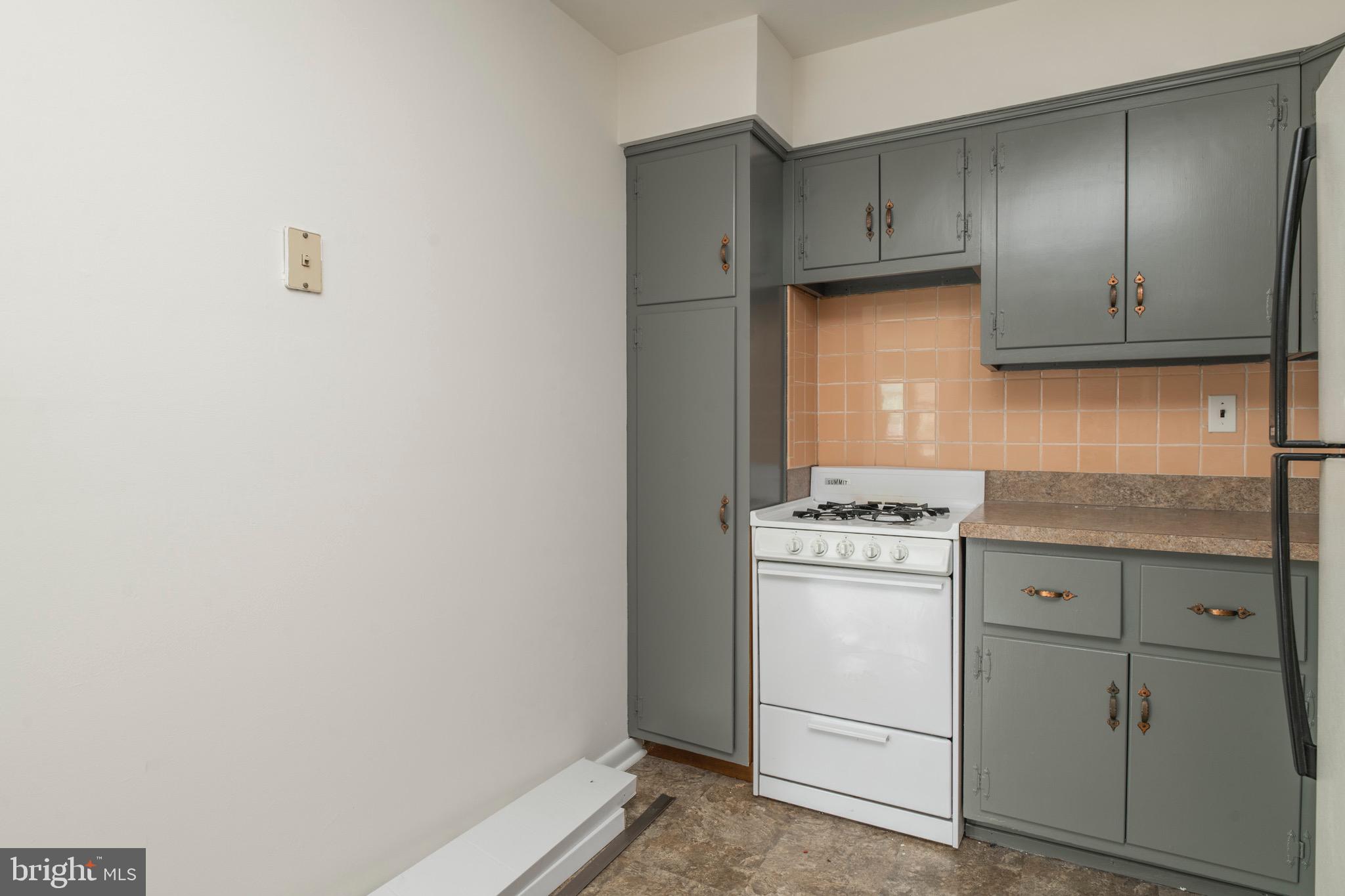 2730 Cranston Road Philadelphia, PA 19131 - Photo 13 of 25 a kitchen with cabinets appliances and a window