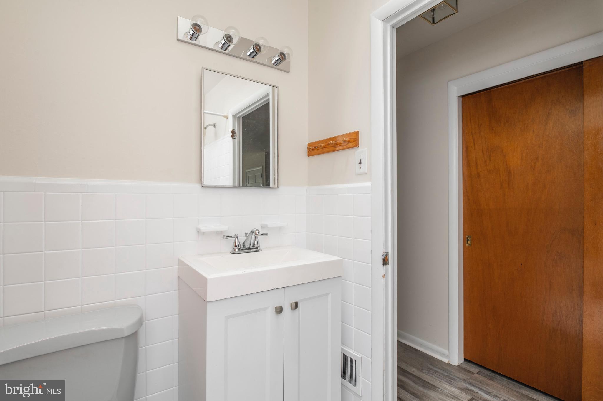 2730 Cranston Road Philadelphia, PA 19131 - Photo 14 of 25 a bathroom with a sink a mirror and vanity