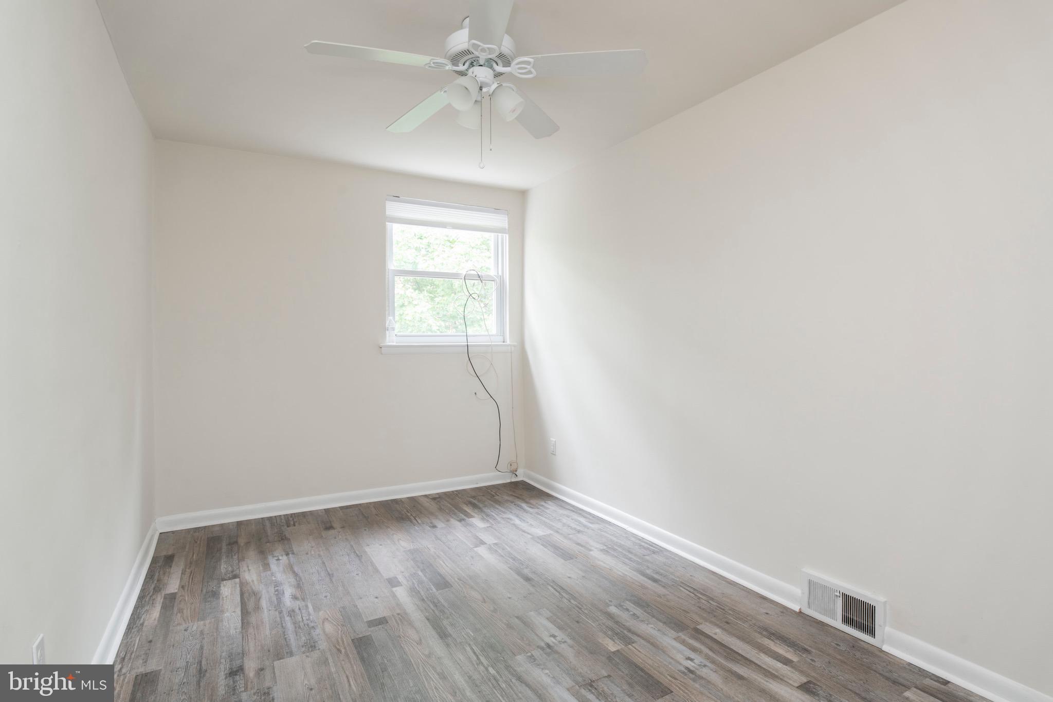 2730 Cranston Road Philadelphia, PA 19131 - Photo 17 of 25 an empty room with wooden floor and windows