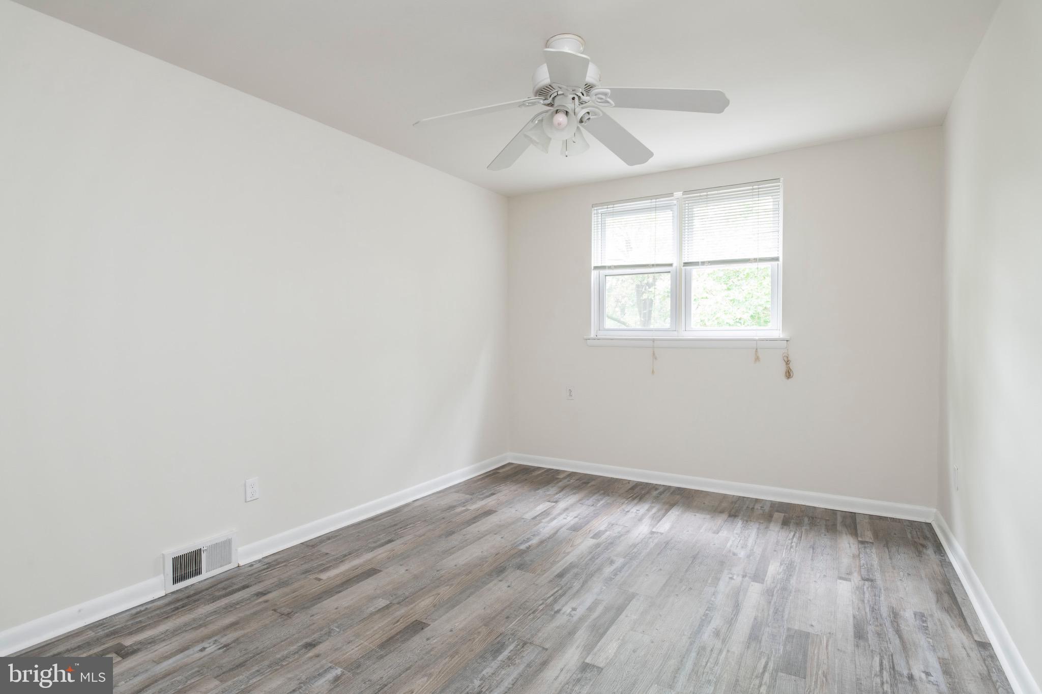 2730 Cranston Road Philadelphia, PA 19131 - Photo 20 of 25 an empty room with wooden floor and windows