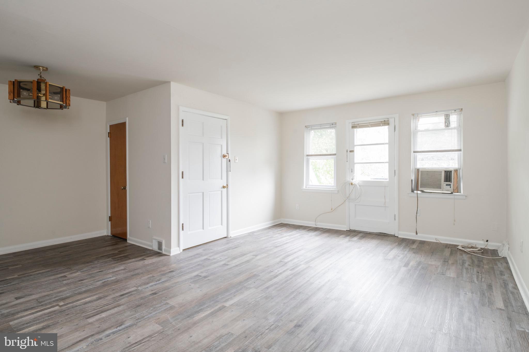 2730 Cranston Road Philadelphia, PA 19131 - Photo 6 of 25 an empty room with wooden floor and windows