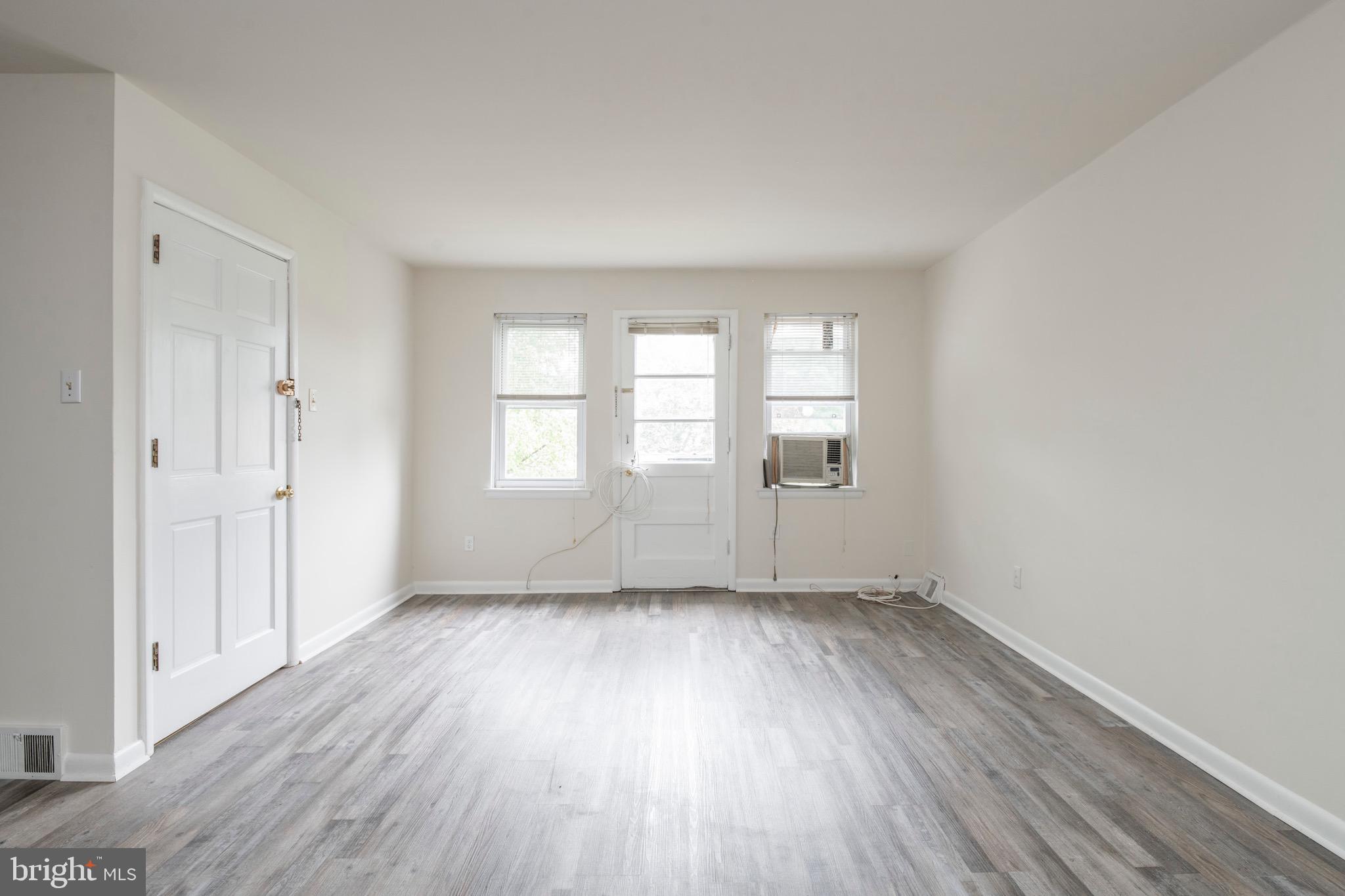 2730 Cranston Road Philadelphia, PA 19131 - Photo 7 of 25 an empty room with wooden floor and windows