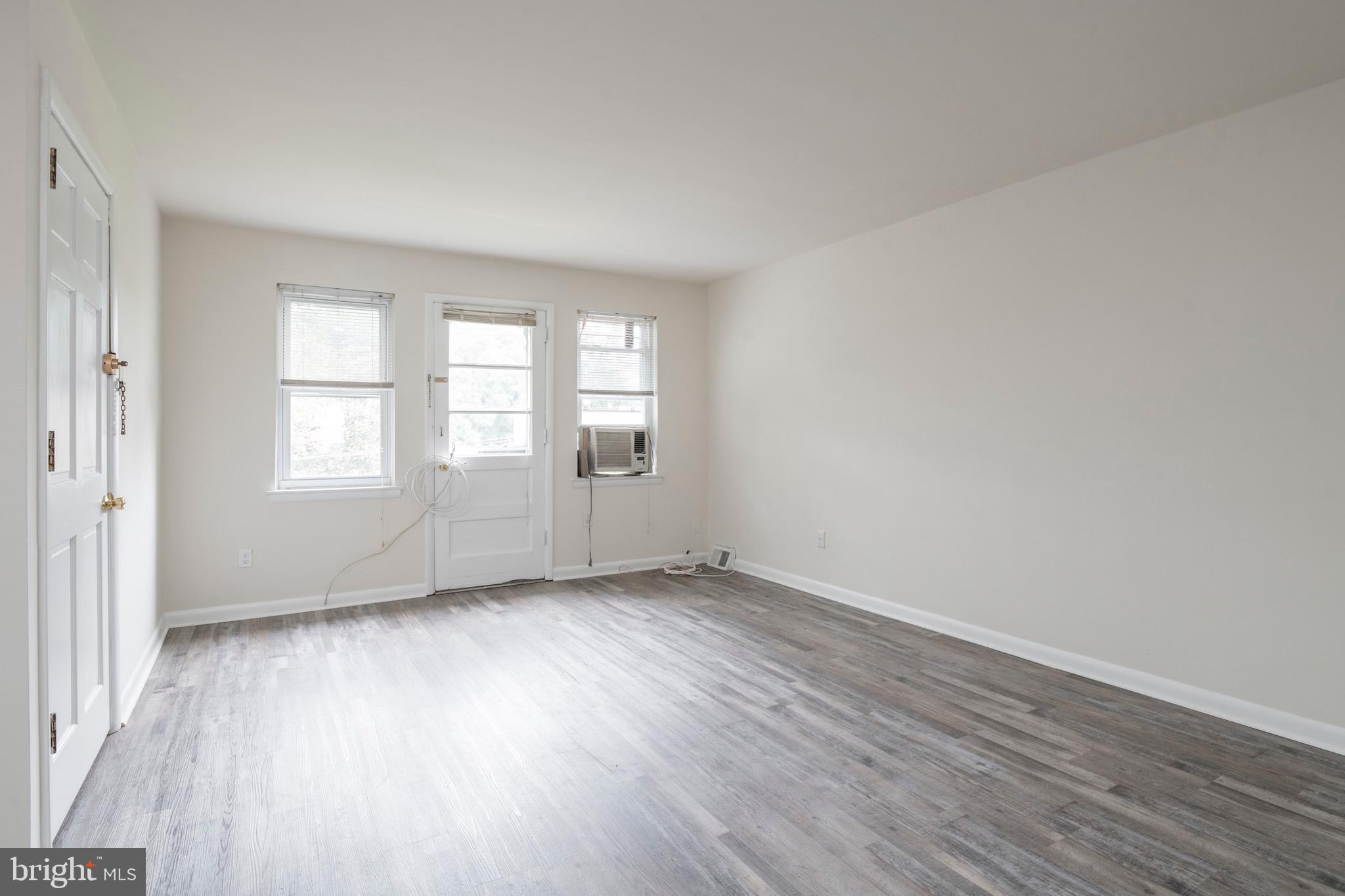 2730 Cranston Road Philadelphia, PA 19131 - Photo 8 of 25 an empty room with wooden floor and windows
