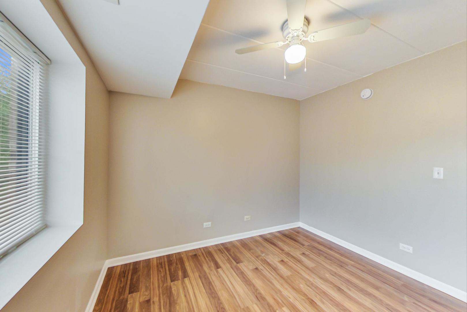 7326 40th Street, Unit 4D Lyons, IL 60534 - Photo 14 of 22 wooden floor in an empty room with a window