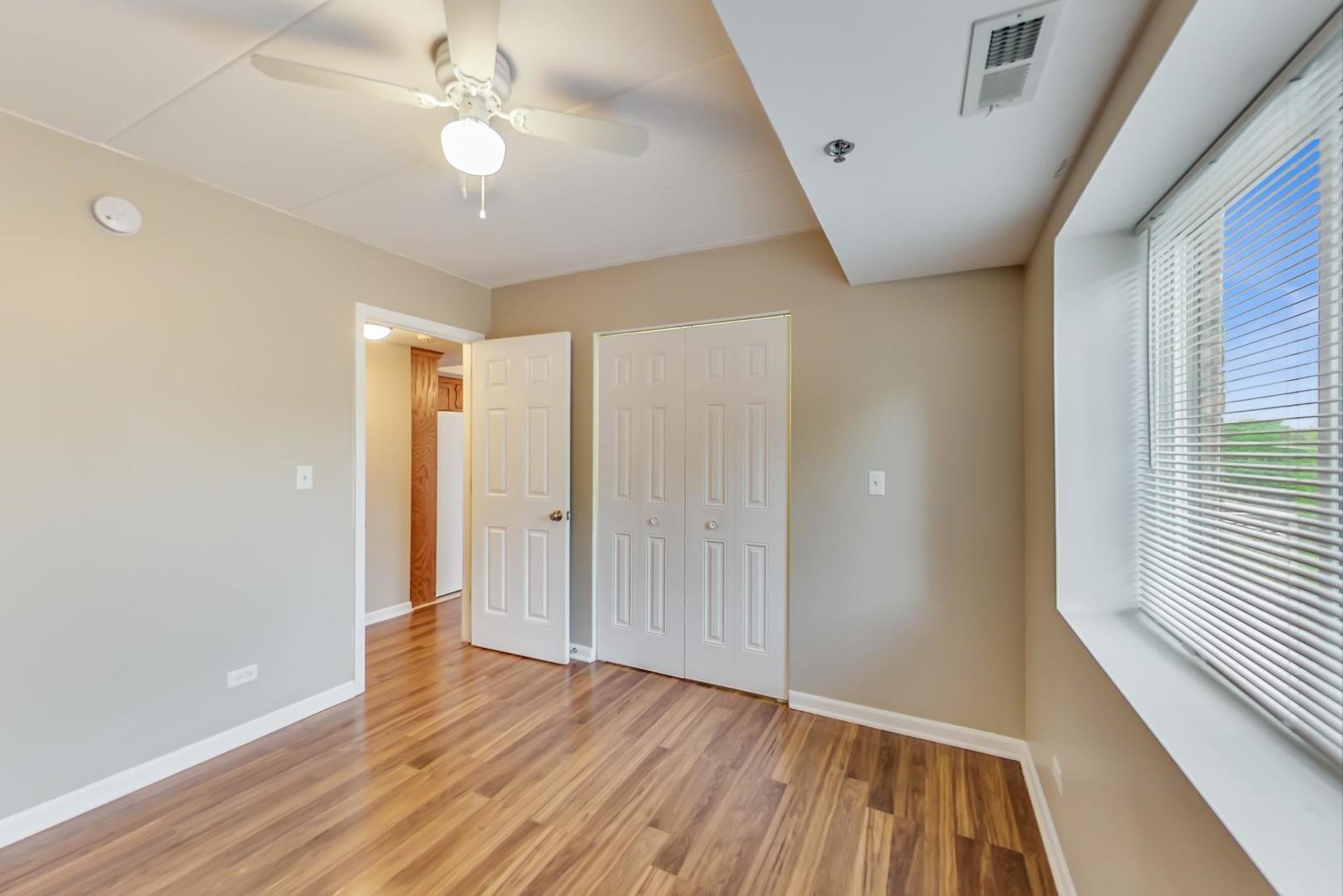 7326 40th Street, Unit 4D Lyons, IL 60534 - Photo 15 of 22 wooden floor in an empty room with a window