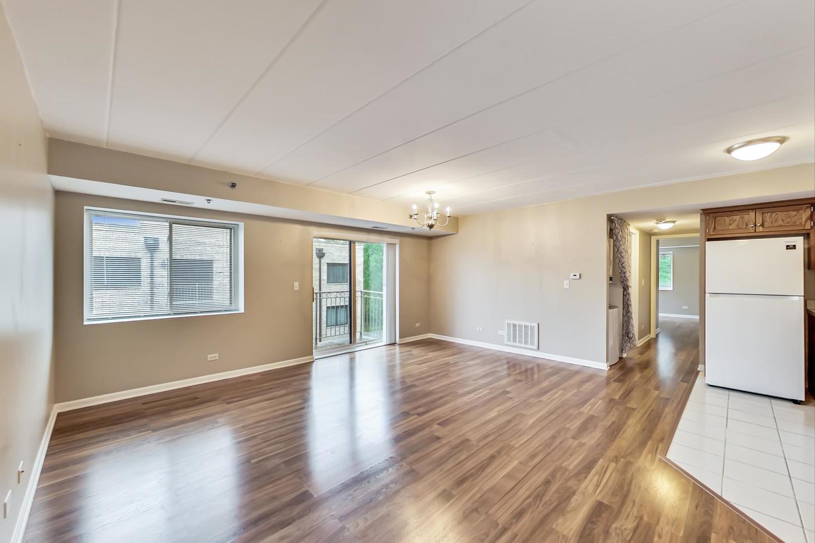 7326 40th Street, Unit 4D Lyons, IL 60534 - Photo 3 of 22 a view of an empty room with window and wooden floor
