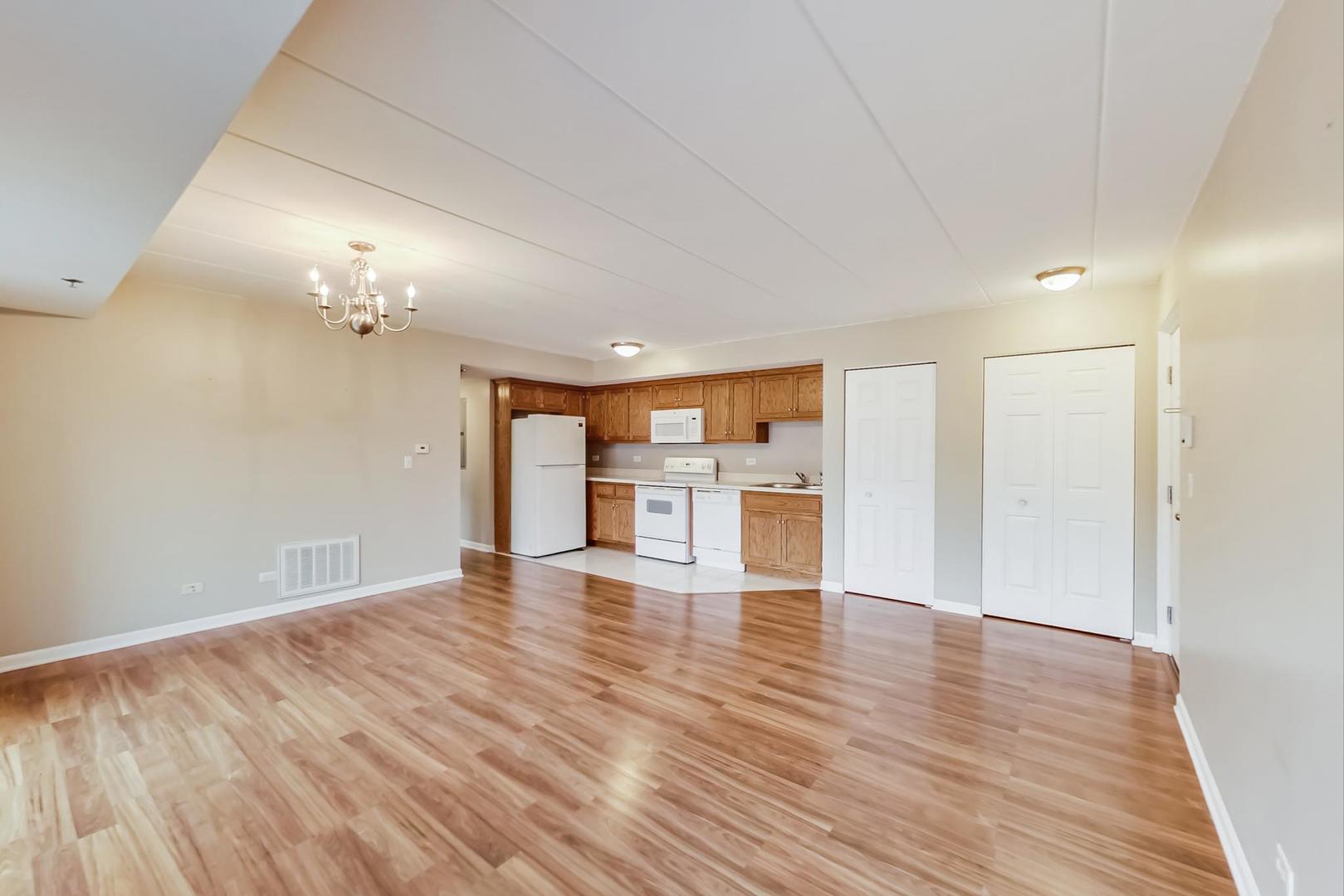 7326 40th Street, Unit 4D Lyons, IL 60534 - Photo 4 of 22 a view of an empty room with wooden floor