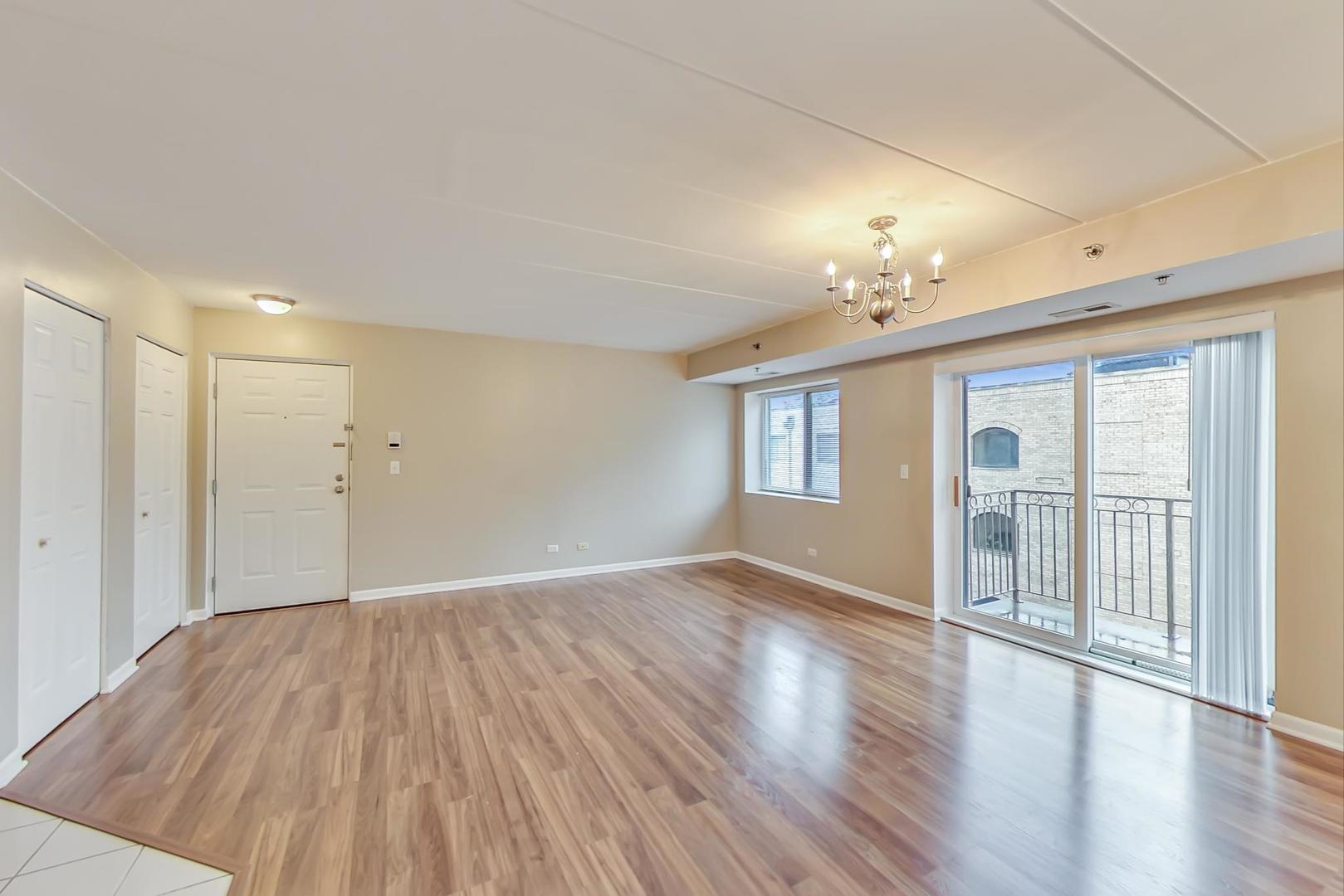 7326 40th Street, Unit 4D Lyons, IL 60534 - Photo 5 of 22 a view of an empty room with a window and wooden floor