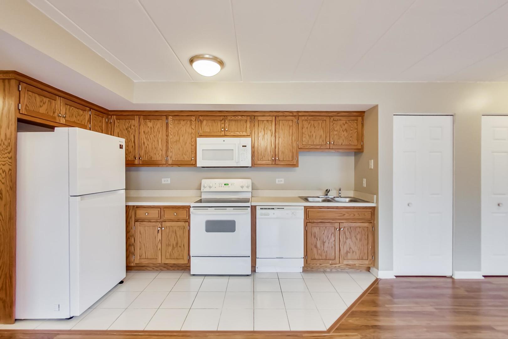 7326 40th Street, Unit 4D Lyons, IL 60534 - Photo 6 of 22 a kitchen with a stove a refrigerator and a sink