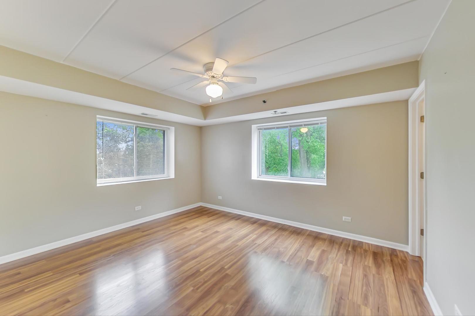 7326 40th Street, Unit 4D Lyons, IL 60534 - Photo 8 of 22 a view of an empty room with wooden floor and a window