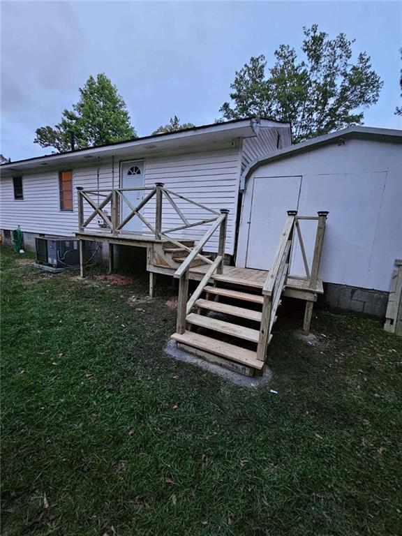 389 Collins Road Toccoa, GA 30577 - Photo 11 of 15 a backyard of a house with wooden floor barbeque oven and a yard