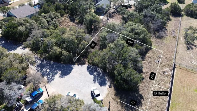 an aerial view of a house with a yard