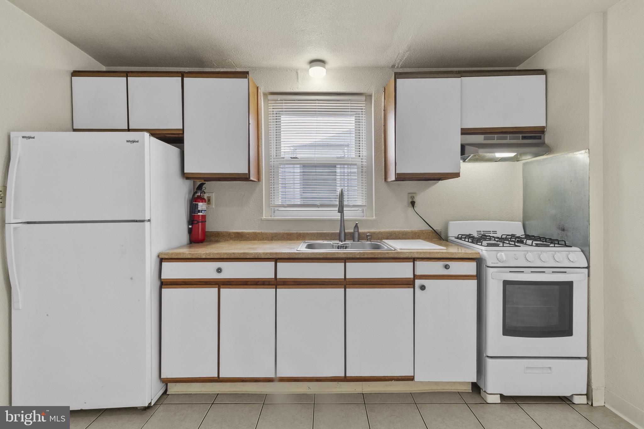 516 Kohn Street Norristown, PA 19401 - Photo 13 of 28 a kitchen with stainless steel appliances granite countertop a sink stove and refrigerator