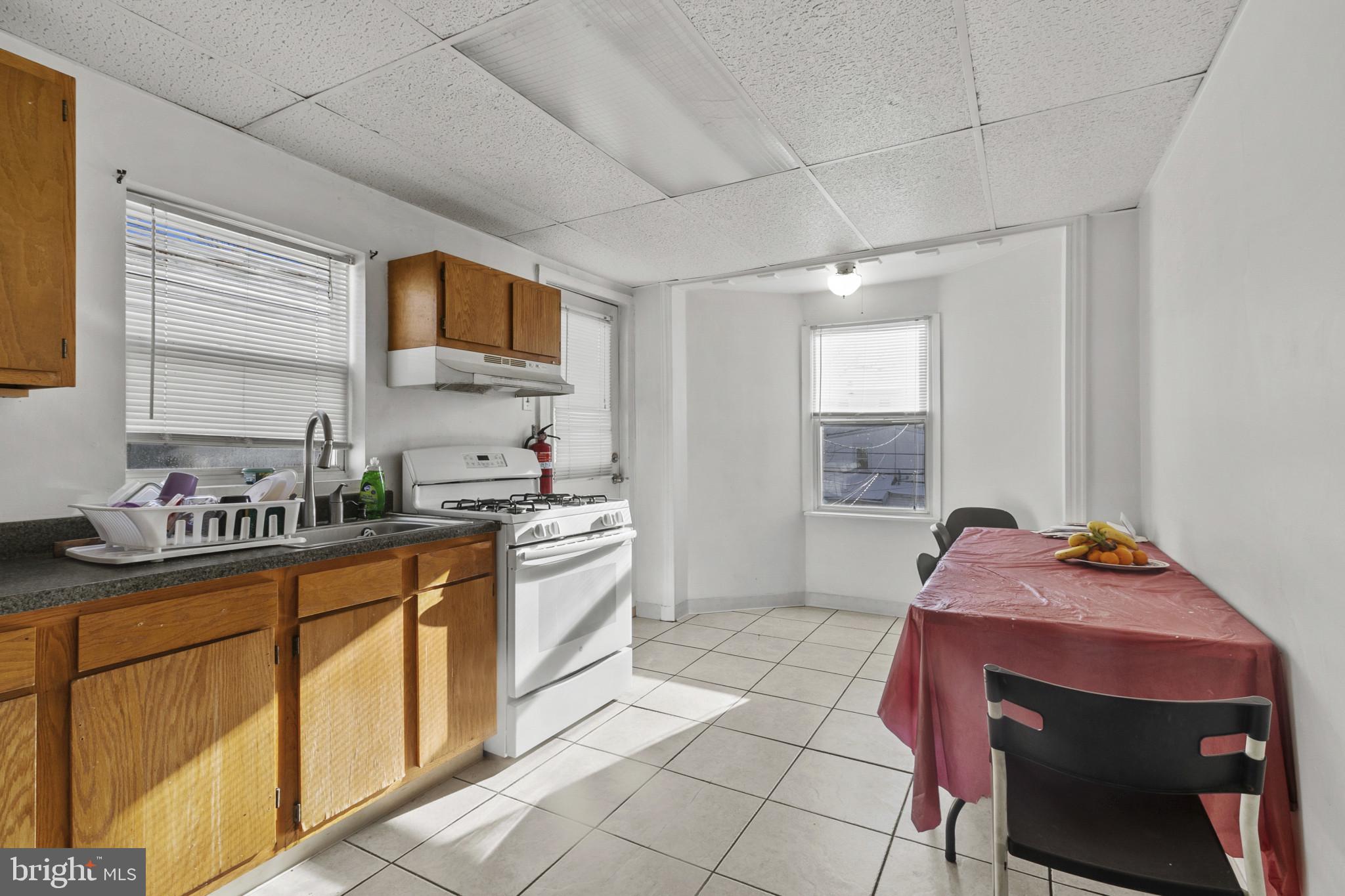 516 Kohn Street Norristown, PA 19401 - Photo 16 of 28 a kitchen with stainless steel appliances granite countertop a sink stove and cabinets