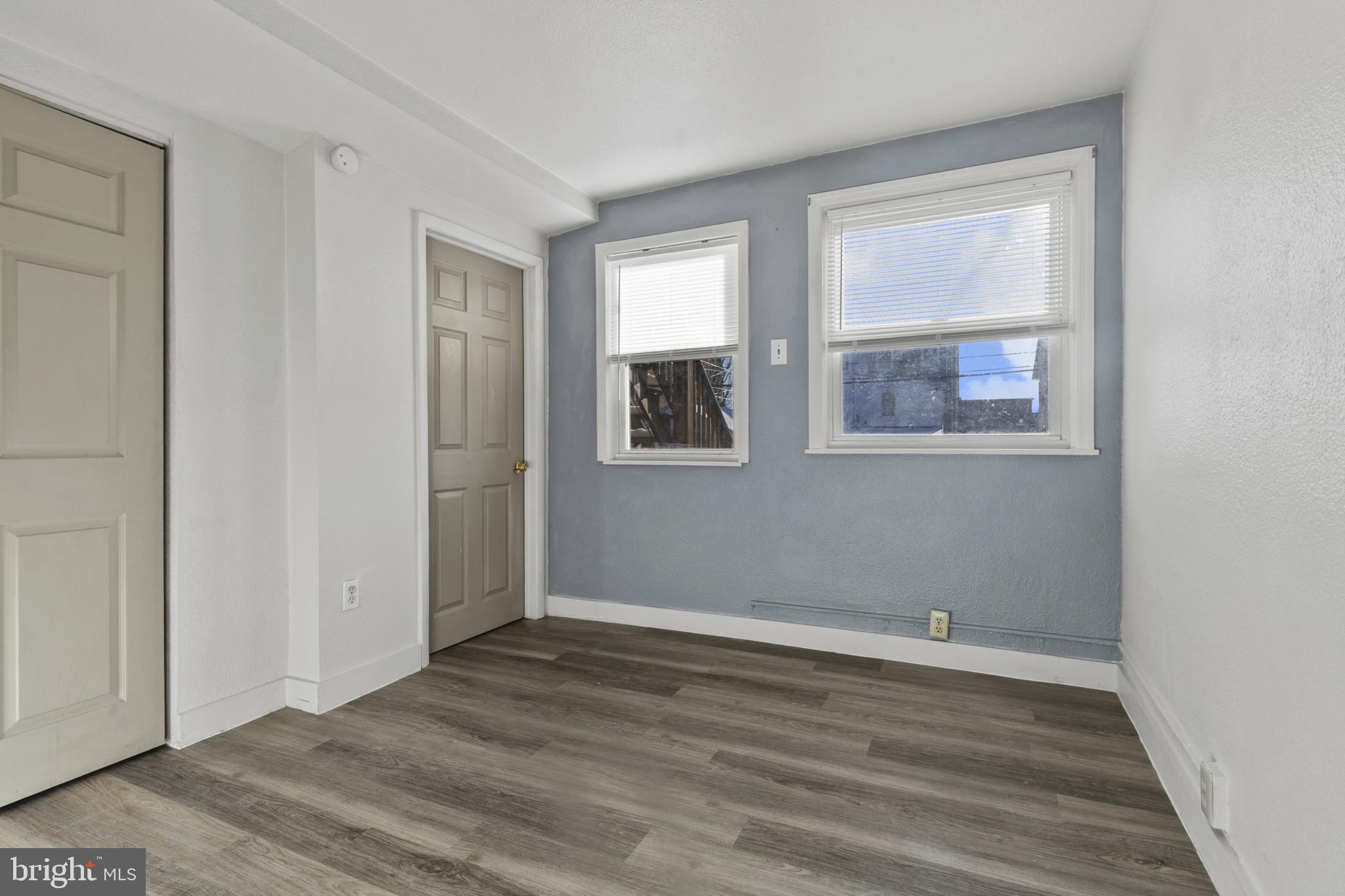 516 Kohn Street Norristown, PA 19401 - Photo 17 of 28 an empty room with wooden floor and windows