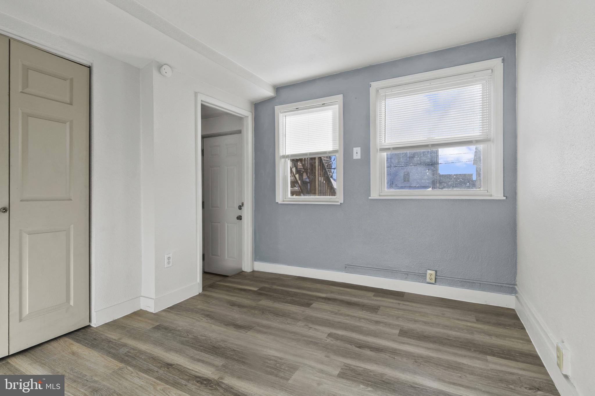 516 Kohn Street Norristown, PA 19401 - Photo 19 of 28 an empty room with wooden floor and windows