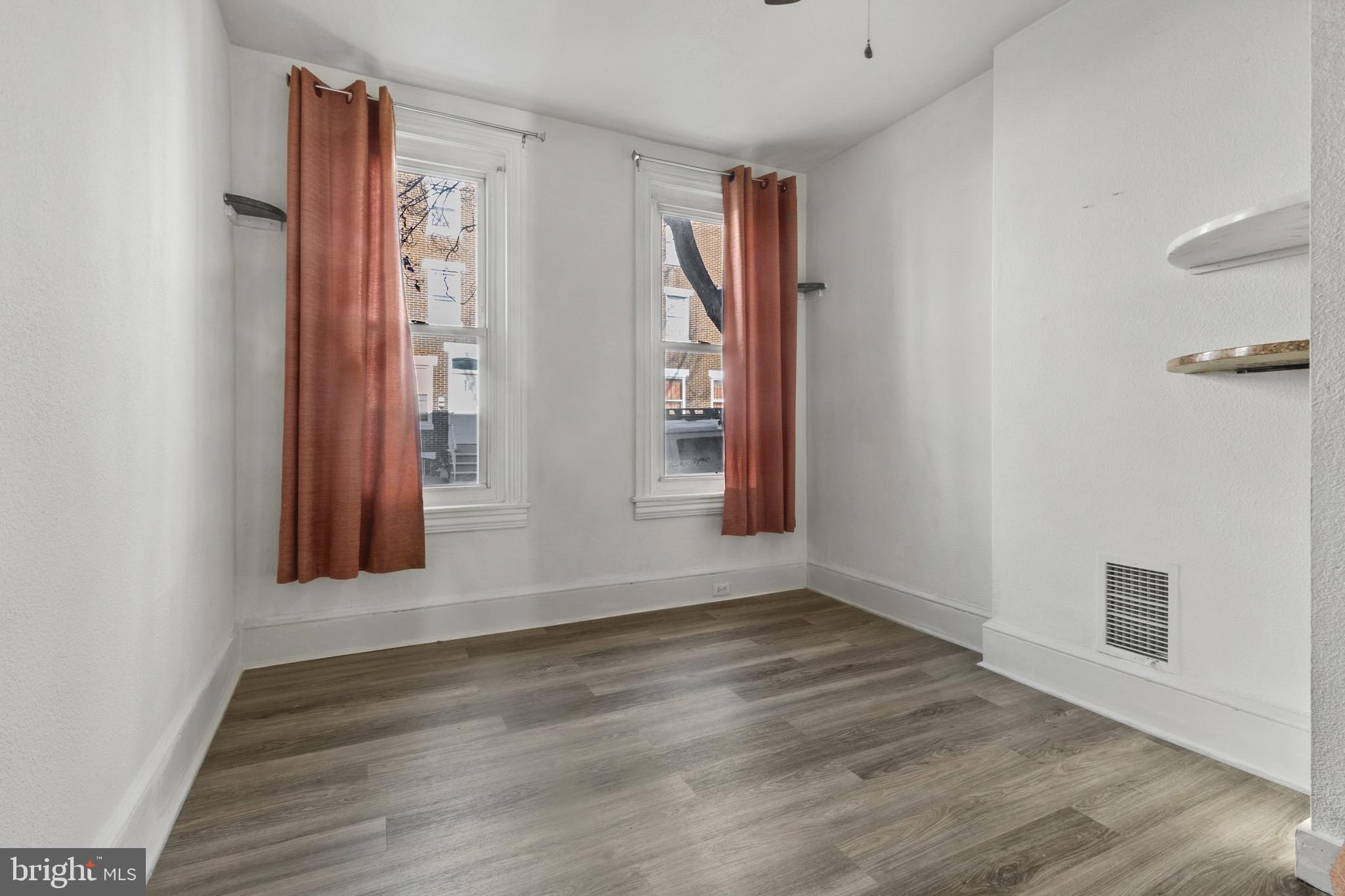 516 Kohn Street Norristown, PA 19401 - Photo 4 of 28 an empty room with wooden floor and windows