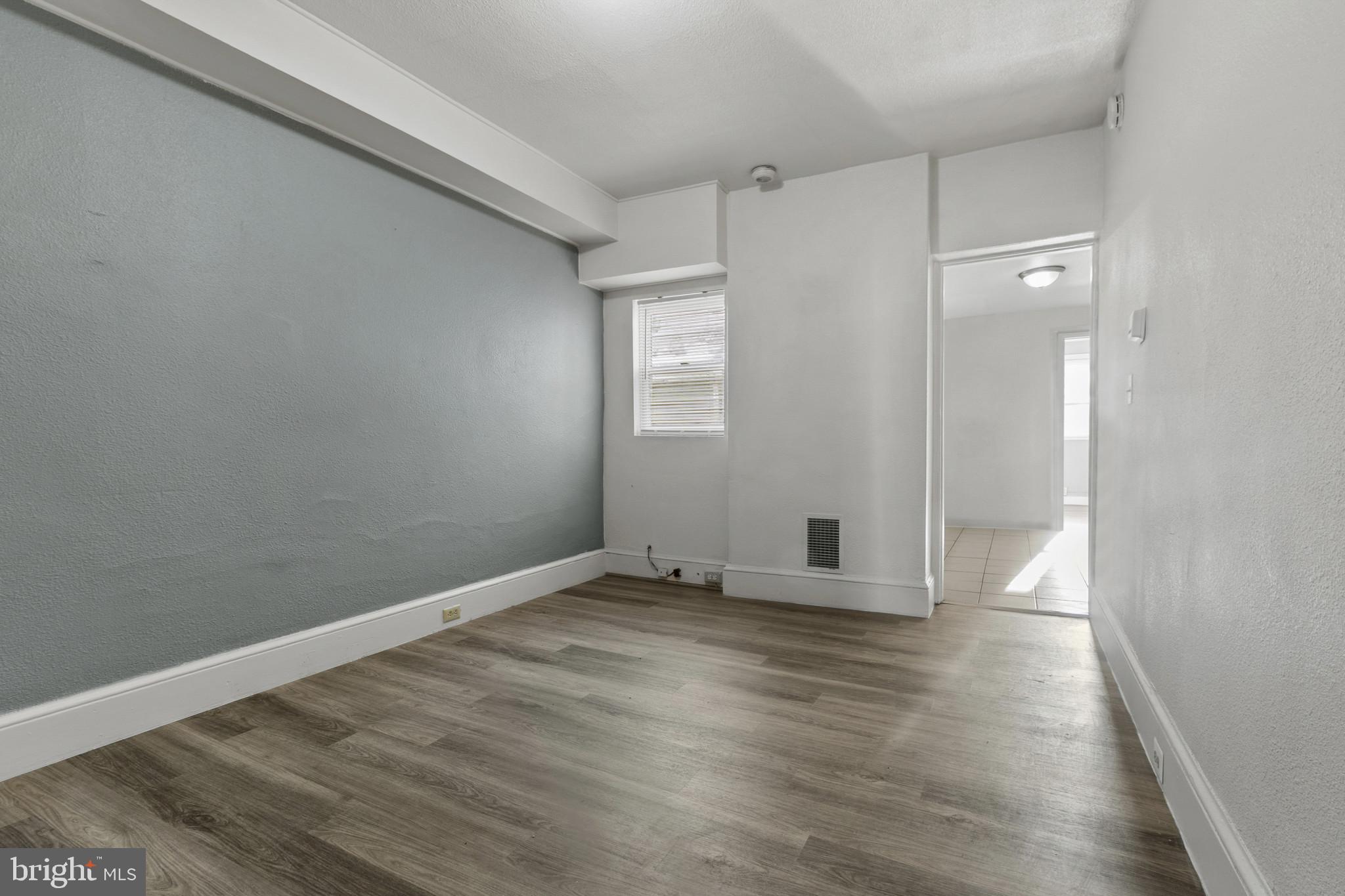 516 Kohn Street Norristown, PA 19401 - Photo 7 of 28 a view of an empty room with wooden floor and a window