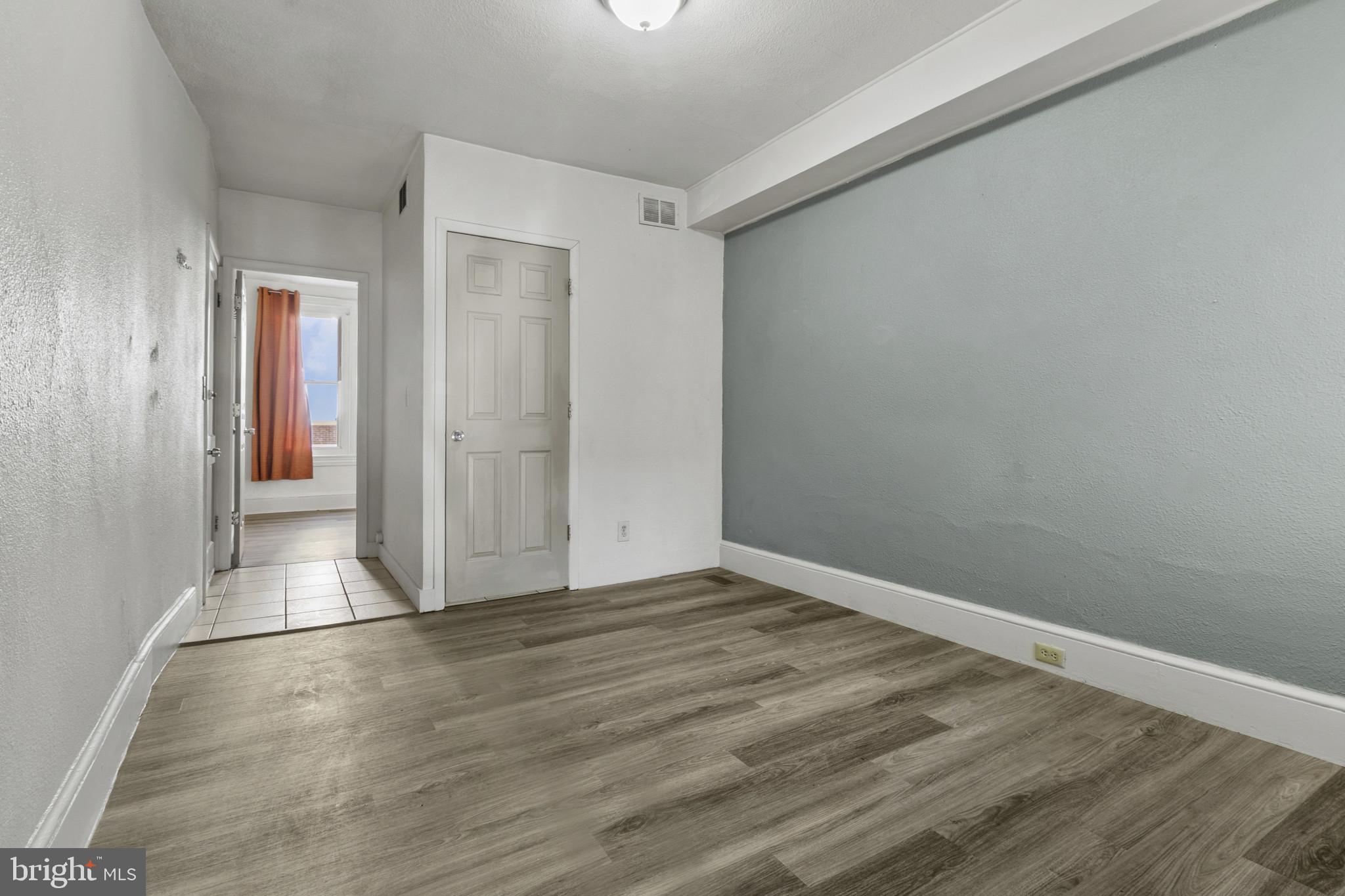 516 Kohn Street Norristown, PA 19401 - Photo 9 of 28 a view of an empty room with wooden floor and closet