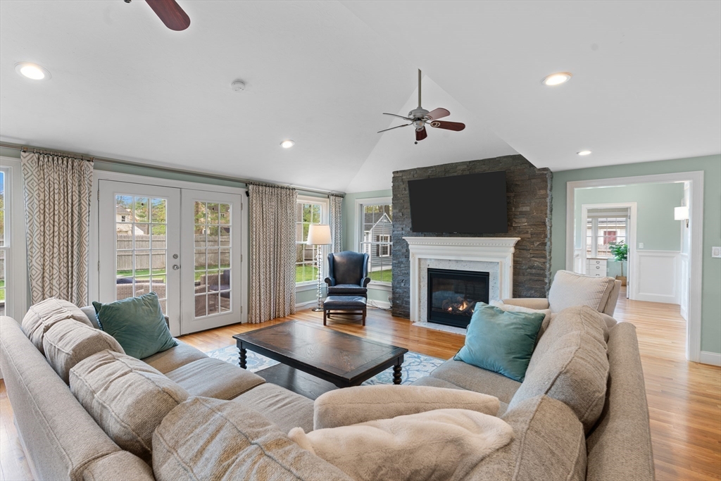 6 Craft Road Natick, MA 01760 - Photo 10 of 42 a living room with furniture a fireplace and a flat screen tv